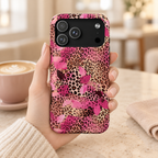 Pink Splash Leopard protective phone case, pink brushstrokes over classic leopard, lifestyle photo in hand with coffee