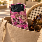 Pink Splash Leopard phone case with card holder, pink brushstrokes over classic leopard, lifestyle photo in a handbag