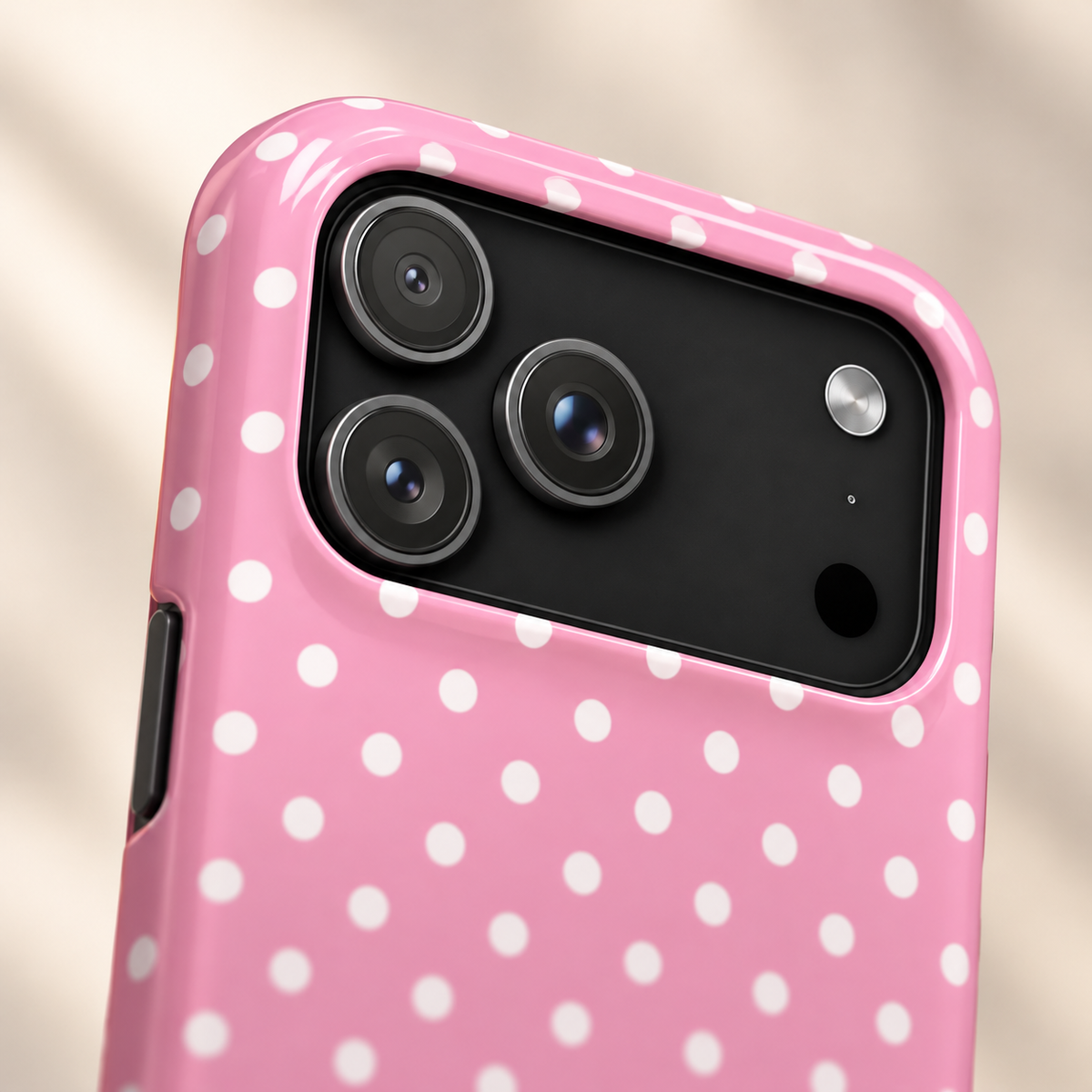 Polka Party protective phone case, bold white polka dots on pink, lifestyle close-up of the camera