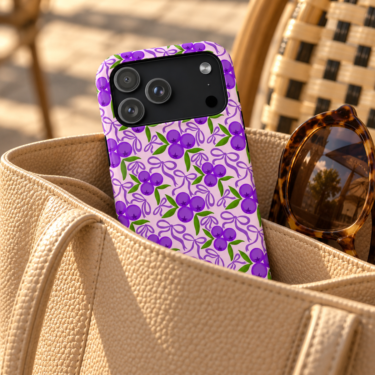 Purple Cherry Bow phone case with card holder, purple cherries and ribbons on lilac, lifestyle photo in a handbag