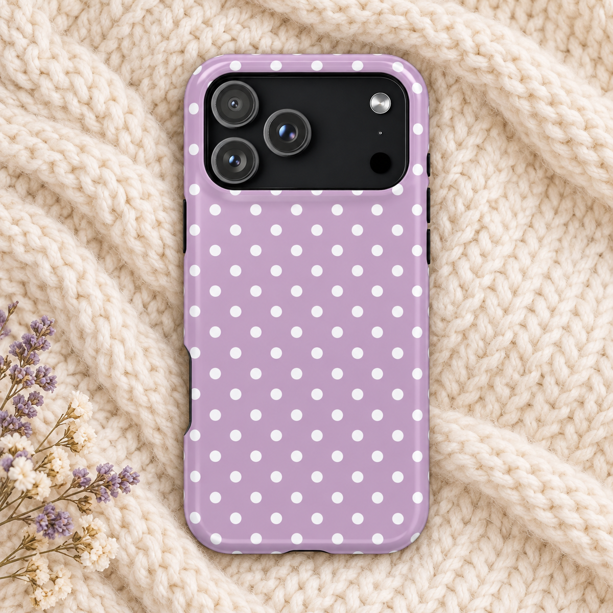 Purple Polka Dot protective phone case, white polka dots on purple, lifestyle photo on a knit blanket