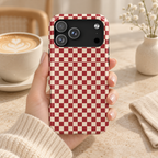 Red Checkered MagSafe case, a red and cream checkerboard, lifestyle photo in hand with coffee