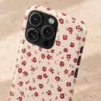 Red Ditsy Floral protective phone case, tiny red flowers on cream, lifestyle close-up of the camera
