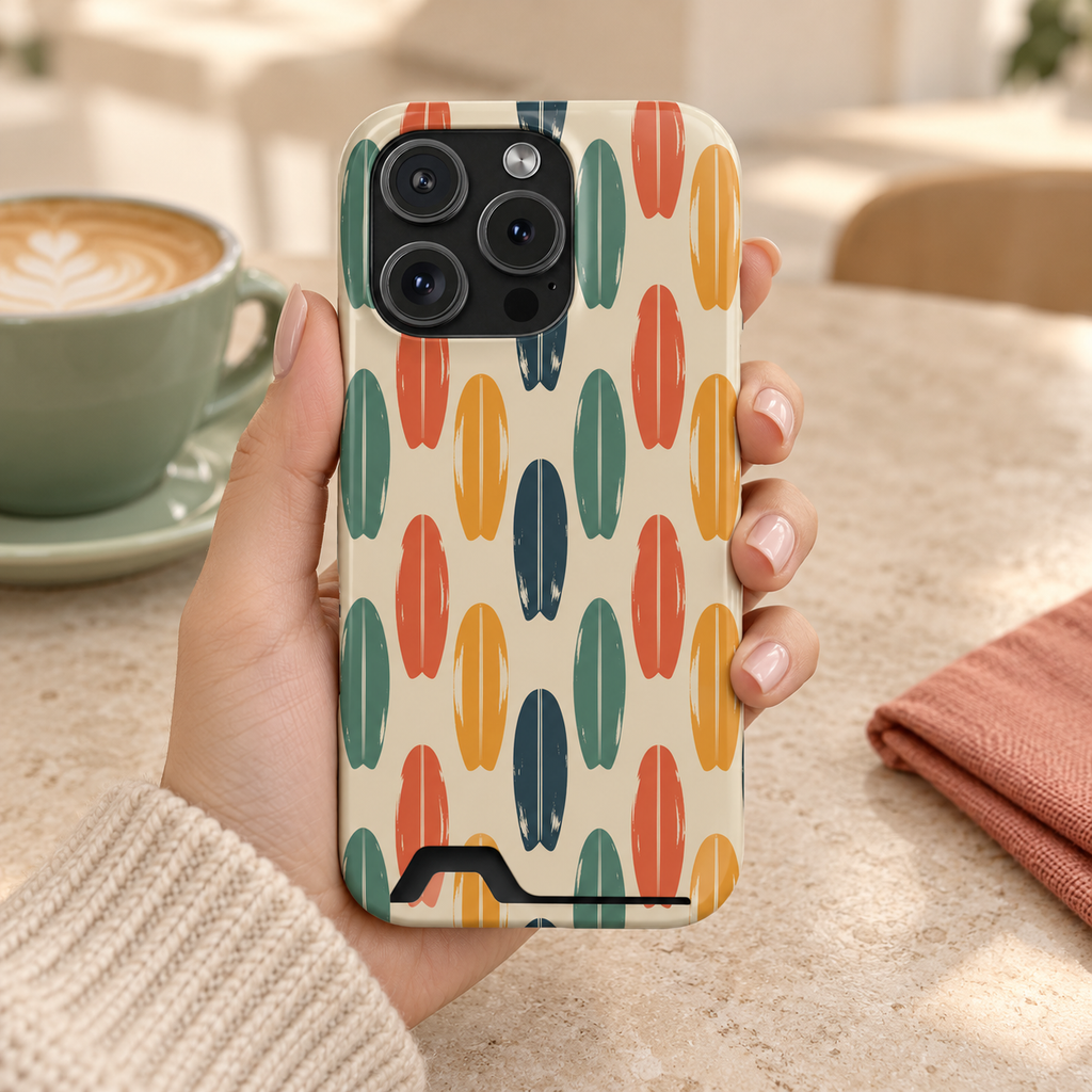 Retro Surfboard phone case with card holder, retro surfboards in orange, green and navy on cream, lifestyle photo in hand with coffee