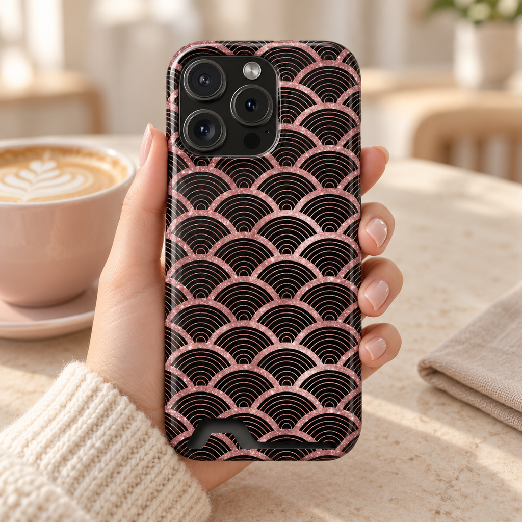 Rose Gold Scale phone case with card holder, rose gold mermaid scales on black, lifestyle photo in hand with coffee