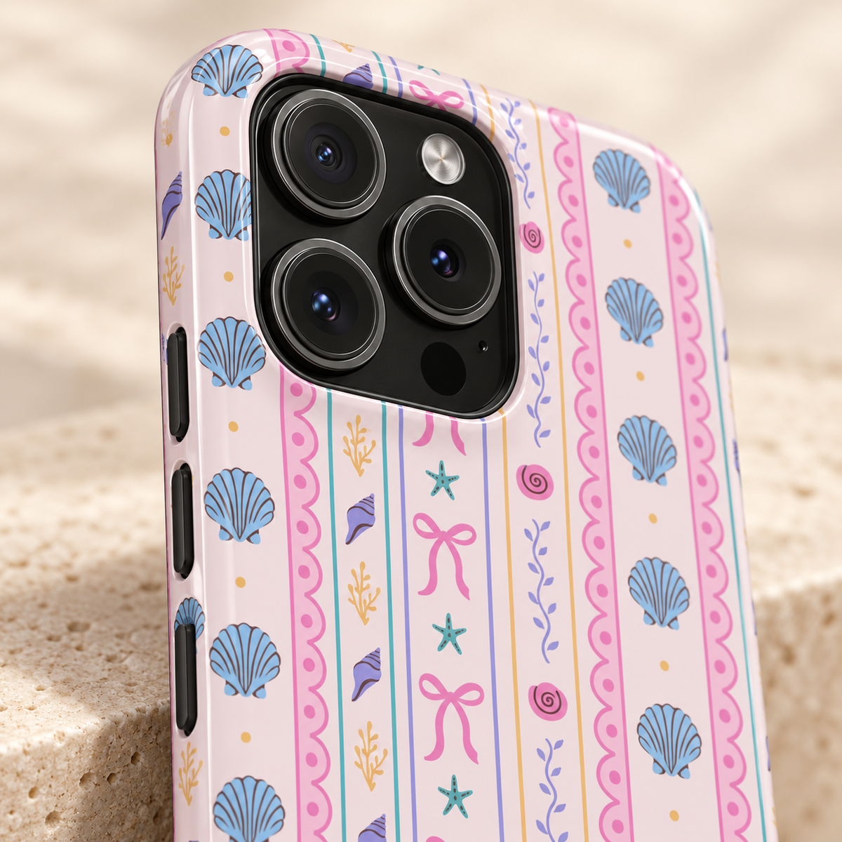Seashell Ribbon protective phone case, seashells, starfish and pink bows in pastel stripes, lifestyle close-up of the camera