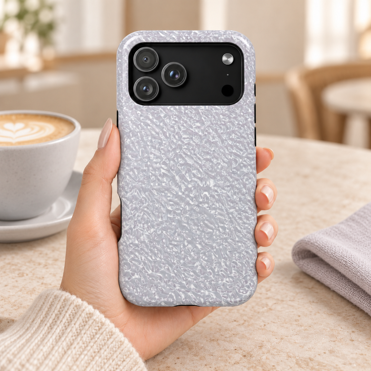 Silver Foil MagSafe case, a crinkled silver foil texture, lifestyle photo in hand with coffee