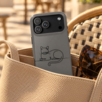 Sleepy Cat MagSafe case, a line-drawn sleeping cat on charcoal gray, lifestyle photo in a handbag