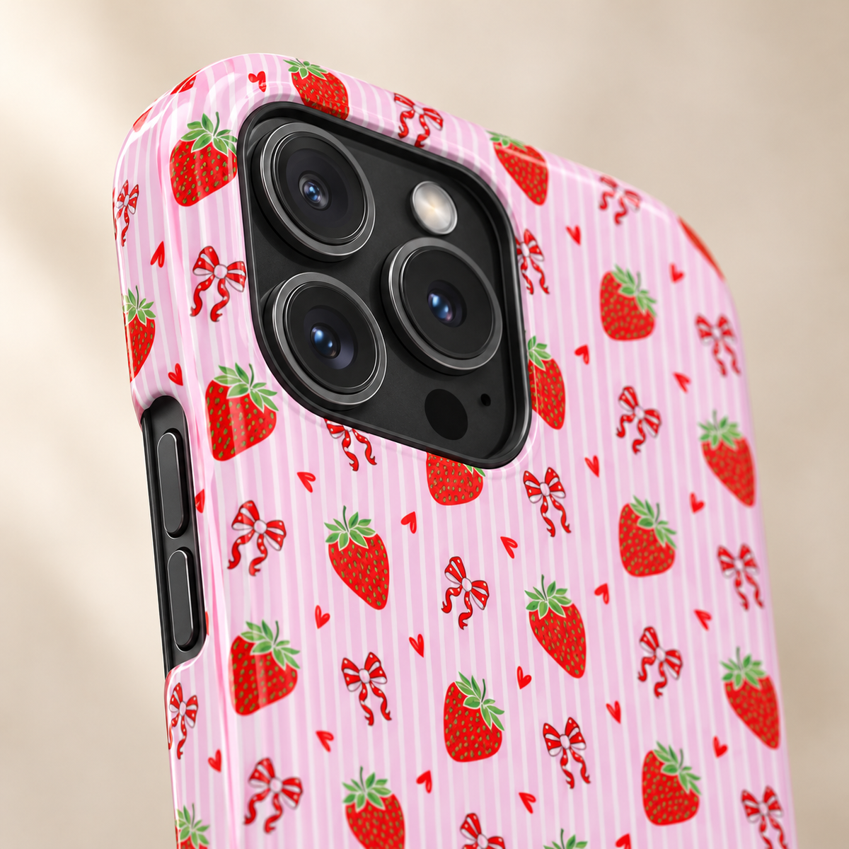 Strawberry Bow MagSafe case, strawberries and red bows on pink stripes, lifestyle close-up of the camera