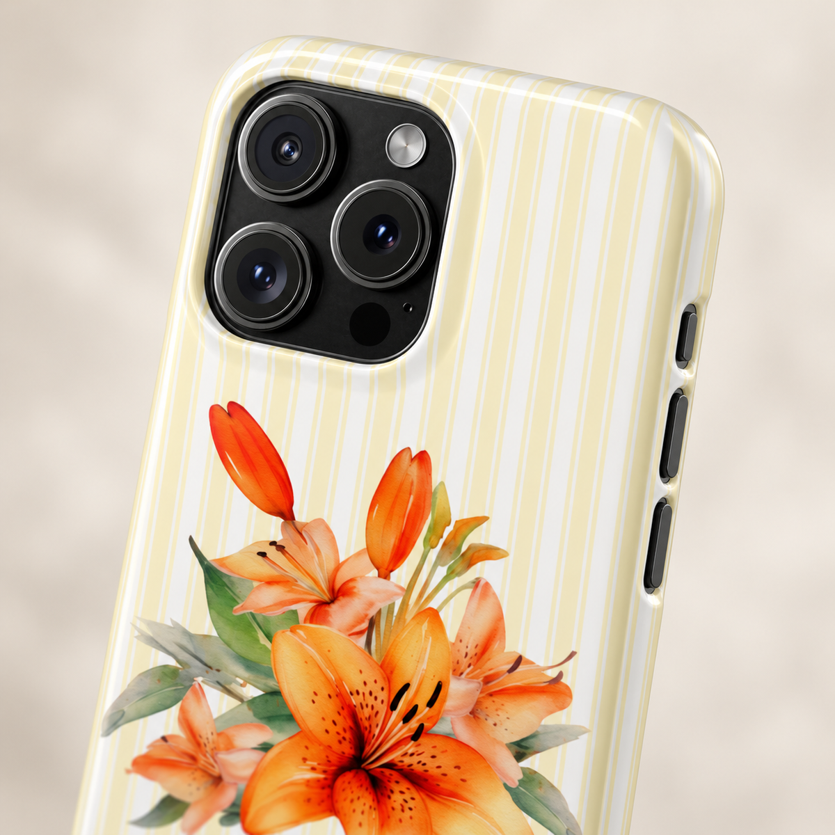 Sunny Lily Stripe protective phone case, orange lilies on pale yellow stripes, lifestyle close-up of the camera