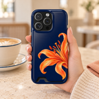 Tiger Lily phone case with card holder, an orange tiger lily on deep navy, lifestyle photo in hand with coffee